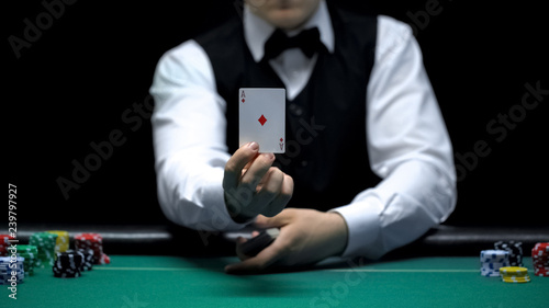 Casino croupier showing ace card in front of camera, poker game shuffling tricks