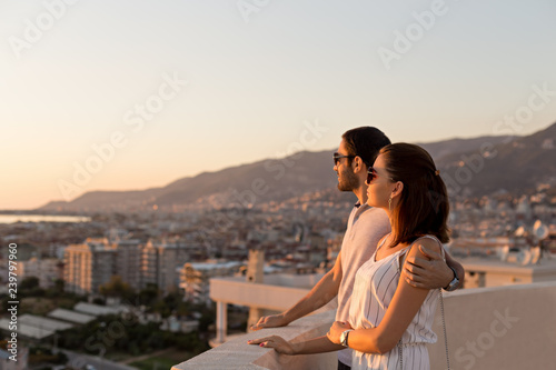 Young couple enjoying a city view from the roof terrace