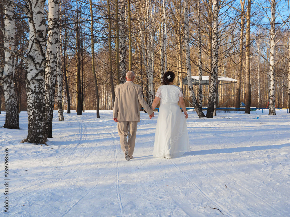 Wedding, newlyweds walk in the park