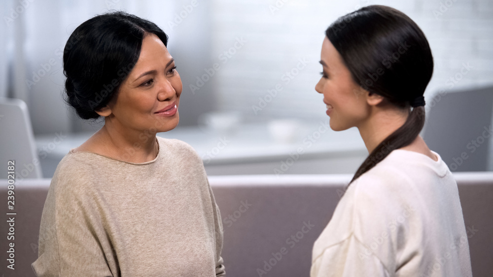 Mother talking to daughter, tenderly looking at her, giving advice, motherhood Mother talking to daughter, tenderly looking at her, giving advice, motherhood