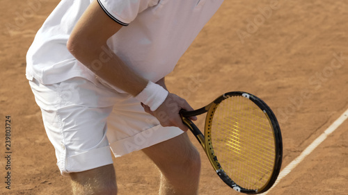 Male tennis player preparing to hit ball, sports competition, active lifestyle © motortion