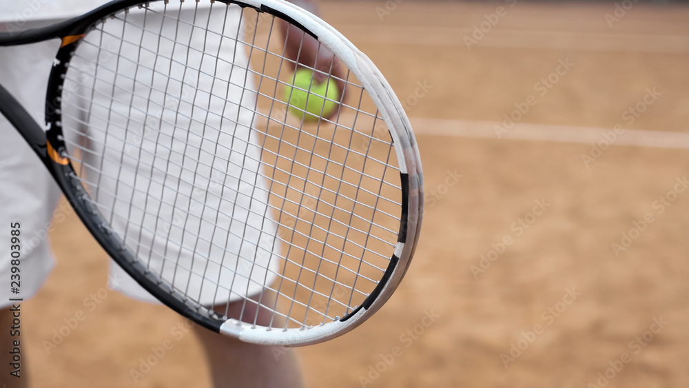 Player with tennis ball preparing to serve, sport equipment, hand close up