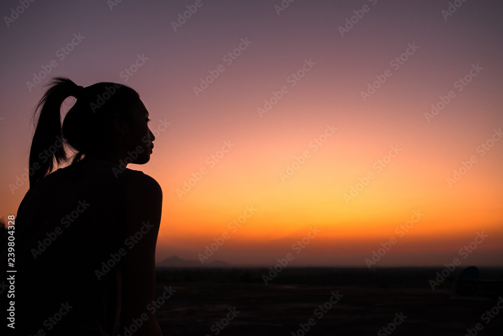 silhouette of young woman at sunset