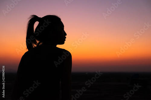 silhouette of young woman at sunset
