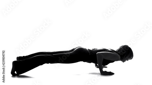 Sport female shadow practicing plank exercise, body strength, pilates training