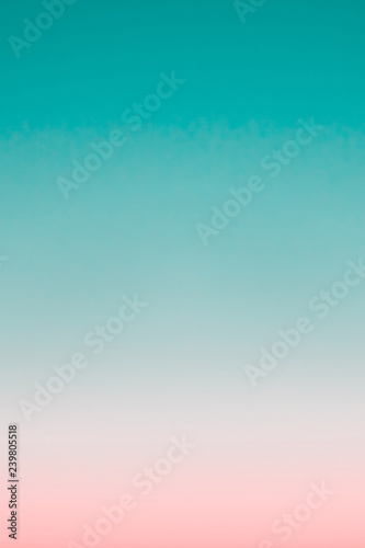 Surreal predawn clear sky with pink horizon and green atmosphere. Smooth pink green gradient of dawn sky. Background of day beginning. Heaven at early morning with copy space. Sunset, sunrise backdrop