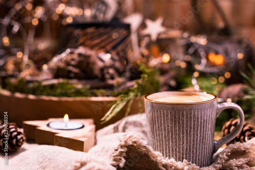 Fresh aromatic coffee and Christmas decor. Cozy festive atmosphere with candles and drinks. Free space for text.