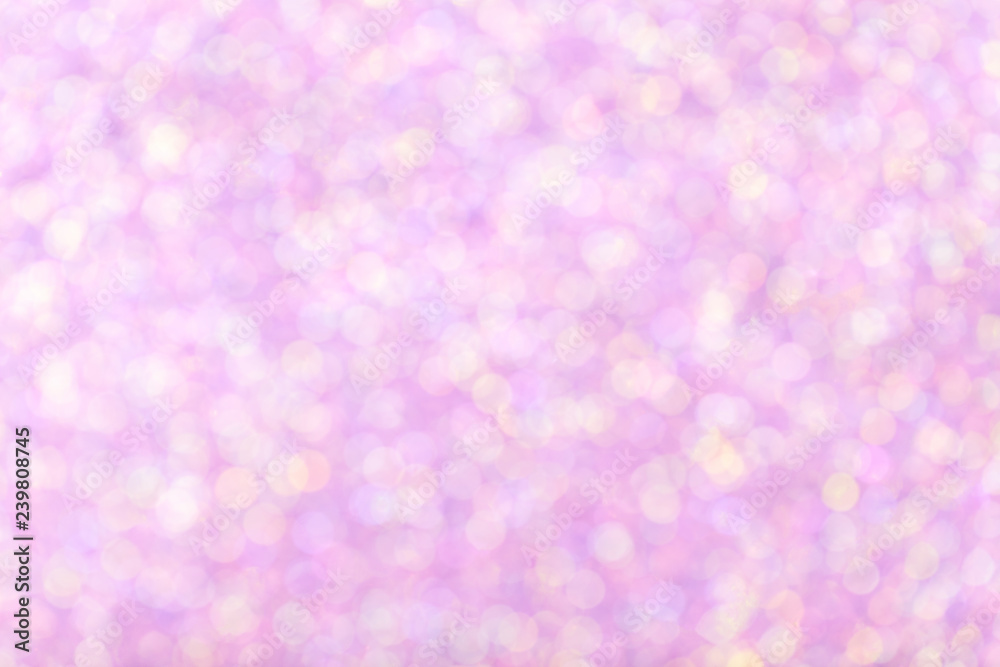 Blurred shiny pink background with sparkling lights.