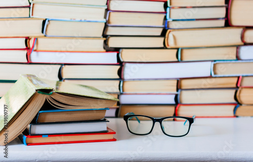 Books background  glasses and open book on white wooden table