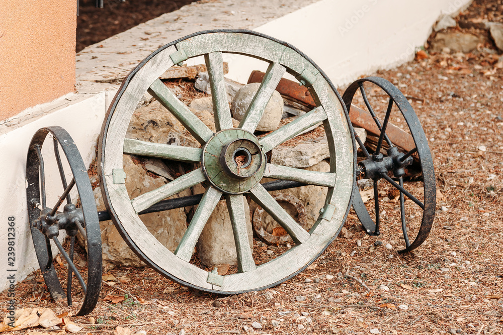 wheel of old wagon. parts from old broken wooden chariots