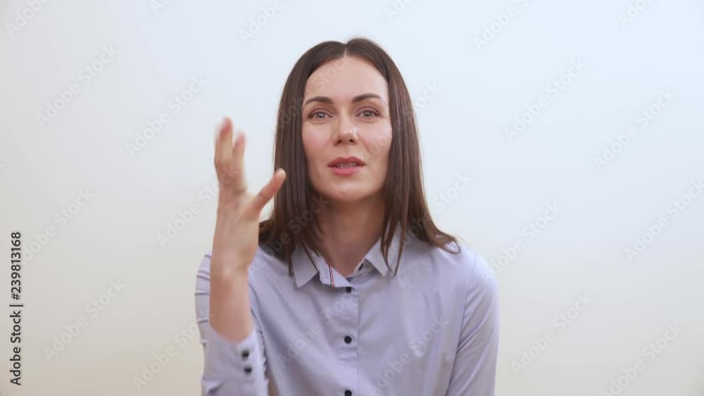 A brunette looking into the camera, squints, makes a fist, wriggles, makes fists with both hands, pounds a bit A brunette looking into the camera, squints, makes a fist, wriggles, makes fists with both hands, pounds a bit