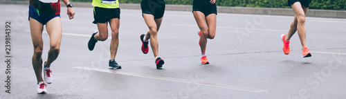 Marathon runners legs running on city road