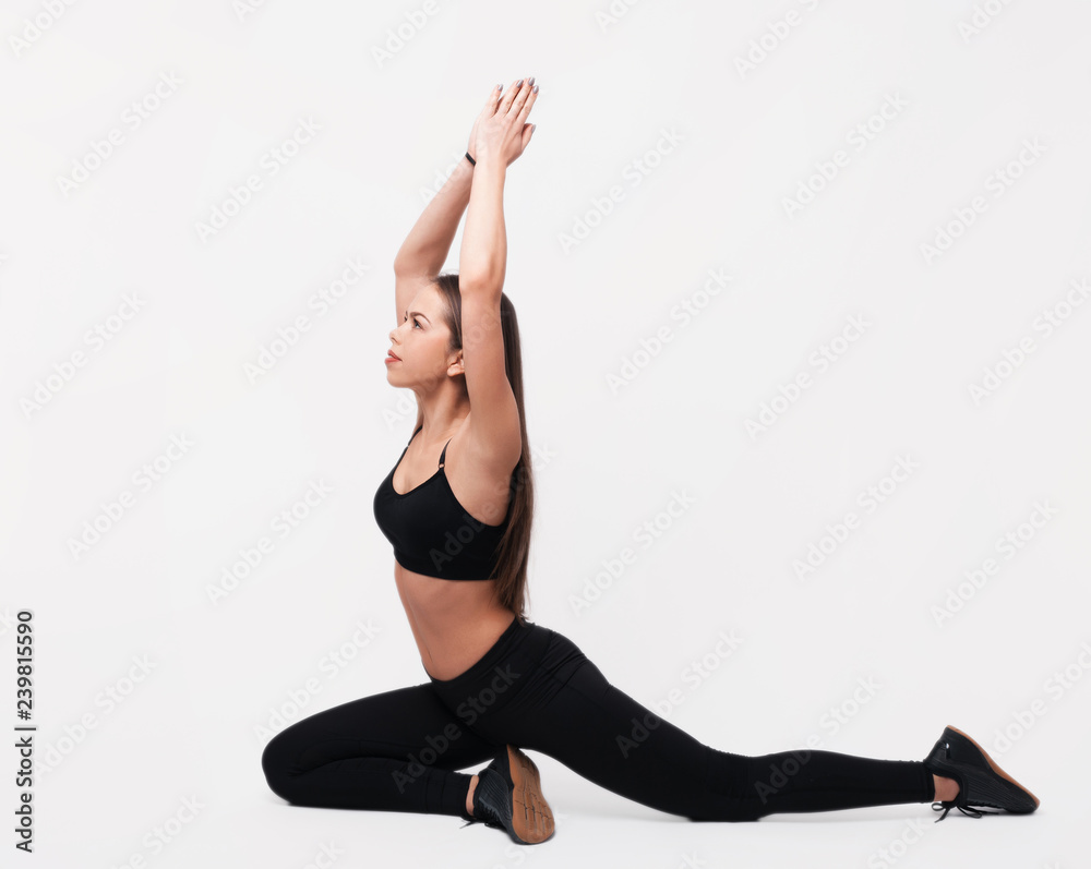 Young woman practicing yoga concept. Working out, wearing sportswear bra and pants. Young woman practicing yoga concept. Working out, wearing sportswear bra and pants.