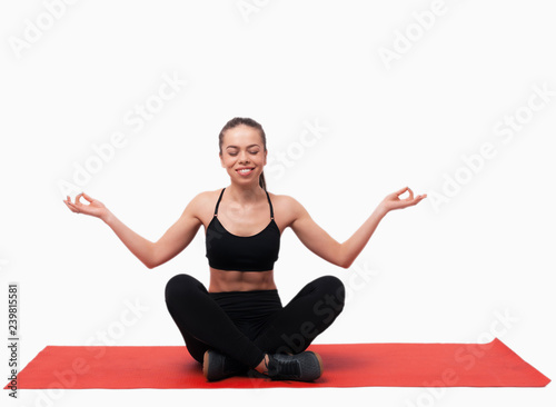 Caucasian young beautiful woman practicing yoga in studio over white background