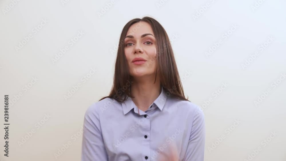 A brunette bites her fingers, makes shifty eyes, takes her hand out of the mouth and looks into the camera, puts her hand down A brunette bites her fingers, makes shifty eyes, takes her hand out of the mouth and looks into the camera, puts her hand down