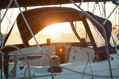  Sailing yacht. Spray hood close-up. Dawn sun