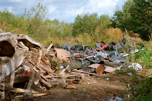 Pollution of the environment by man. Garbage dumping in the forest. Construction and industrial waste in the environment.