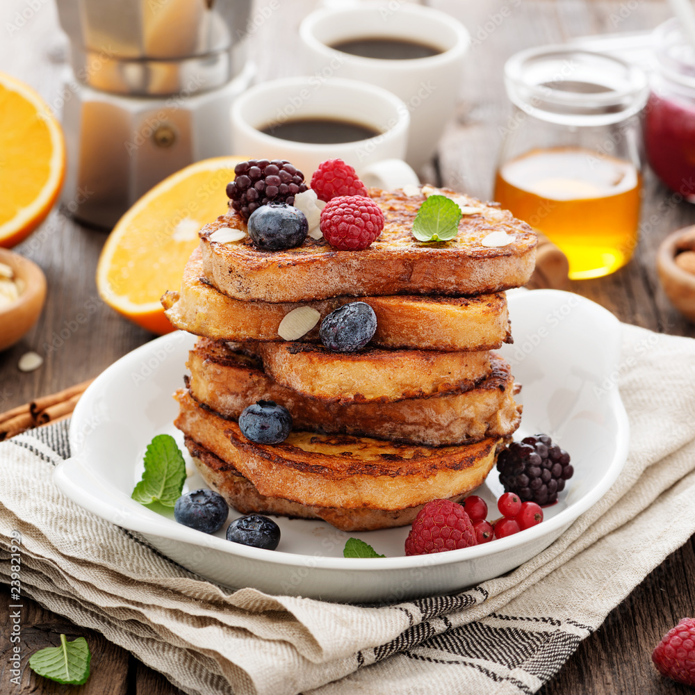 French toasts with fresh berries and honey for breakfast. French toasts with fresh berries and honey for breakfast.