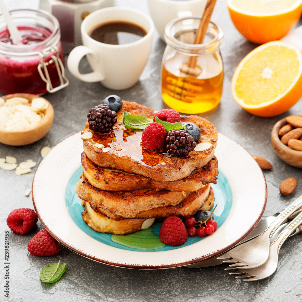 French toasts with fresh berries and honey for breakfast. French toasts with fresh berries and honey for breakfast.
