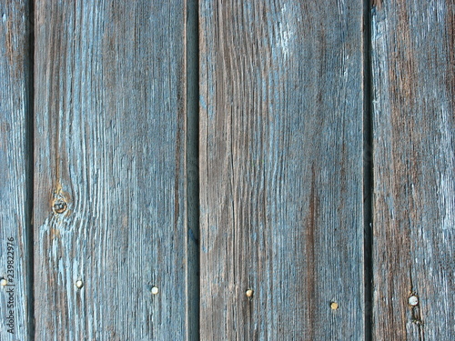 Wood board texture background with blue dry peeling paint and cracks