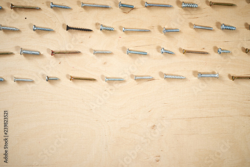 pattern background of various screws on a  wooden work table