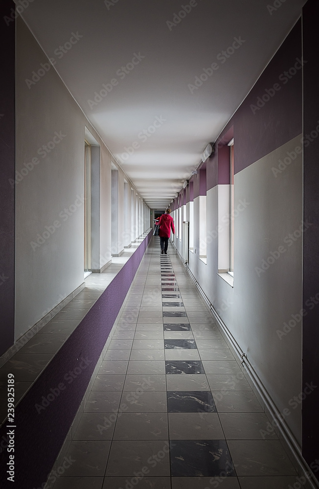 A person walking down the corridor.