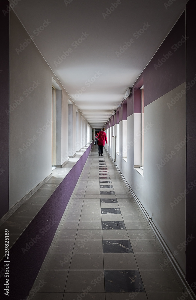 A person walking down the corridor. A person walking down the corridor.