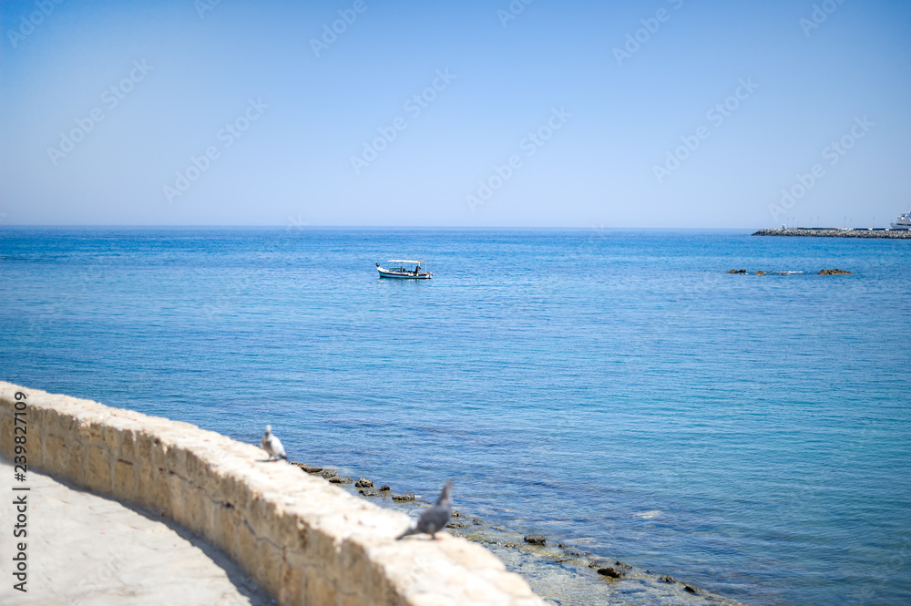 Fishing boat stands in the sea near Kyrenia Castle Fishing boat stands in the sea near Kyrenia Castle