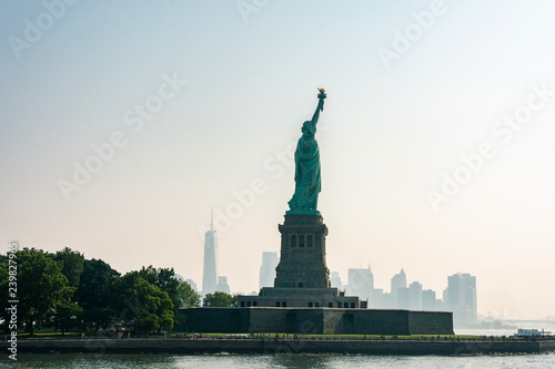 Liberty statue in New York City with skyline of the island of Manhattan © Andrea