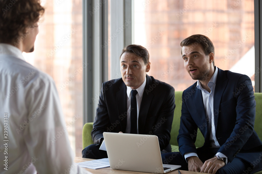 Obraz premium Surprised HR executive managers headhunters or recruitments looking at job vacancy candidature impressed by incredible achievements knowledges. Human resources interview, employment and hiring concept