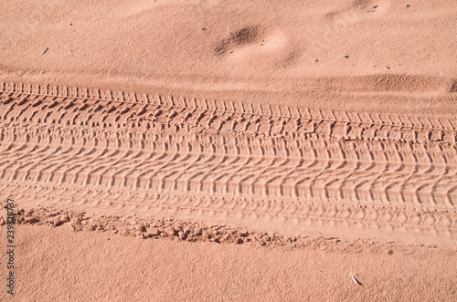 Traces of tires on a jeep in sand in desert photo