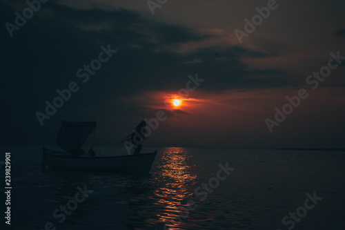 Fisherman tries to collect fishes in sunset