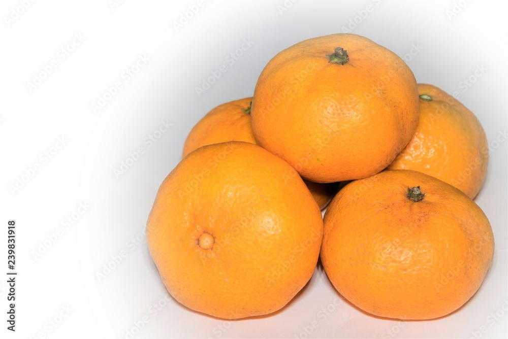 Delicious ripe Christmas tangerines on a white background. Delicious ripe Christmas tangerines on a white background.