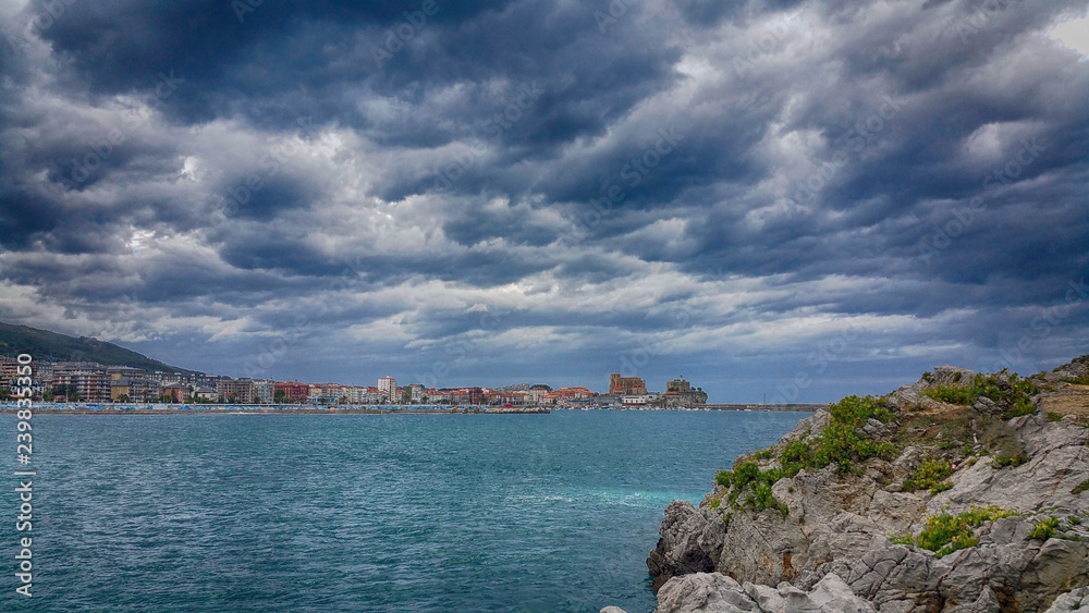 view on the Castro-Urdiales, Cantabria, North Spain. Dramatic dark sky over seascape.
