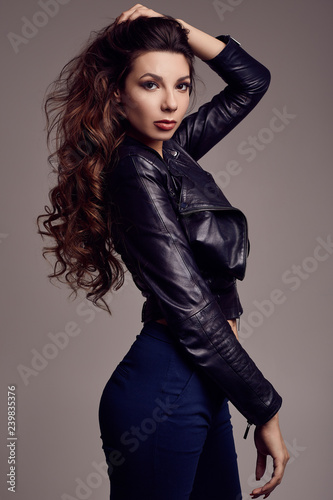 Young sexy girl with long hair in leather jacket
