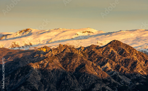 Beautiful scenic photo of Sierra Nevada snowcapped mountains during golden hour, Granada