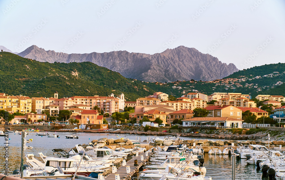 Stunning view of the corsica high mountain range from the harbour of the city Ille Rouse