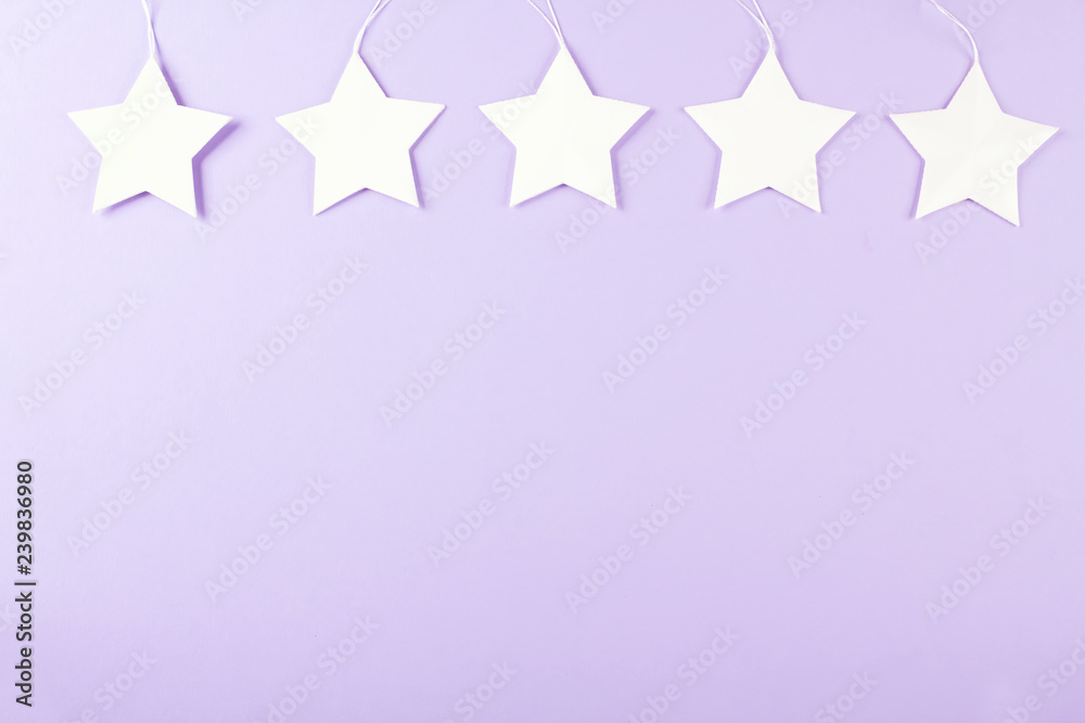 White star, purple background, party decor. Top view. Copy space.