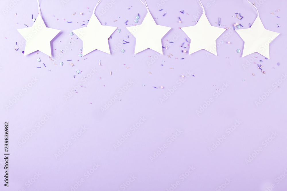 White star, purple background, party decor. Top view. Copy space.