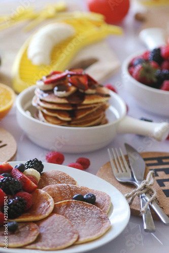 Pancakes served with many fresh fruits and berries