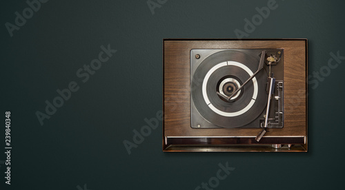 Photography Old vintage retro wooden vinyl record player on green background , oldy music entertainment , top view
