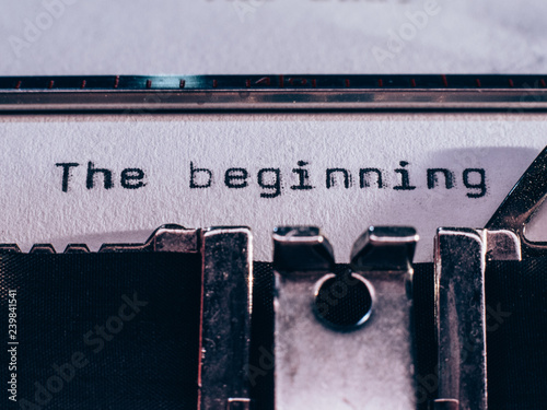 Old typewriter with text 'the beginning' photo