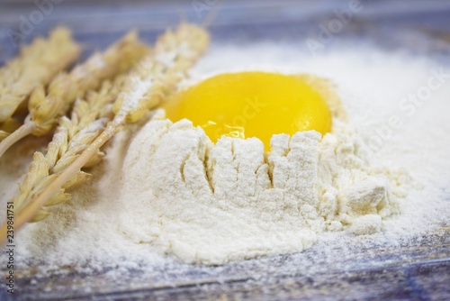 Prepare the dough for baking homemade cookies.Egg and flour on wooden background.