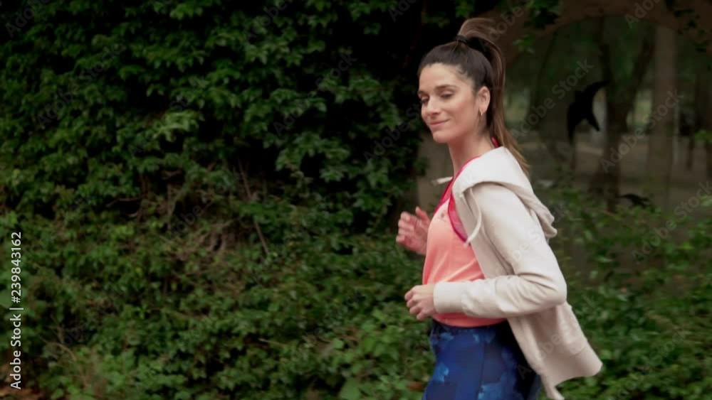 Slowmotion video of fit woman running in the park . morning sport training Slowmotion video of fit woman running in the park . morning sport training