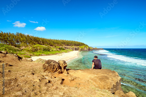 tourist wtaching Beautiful white sand tropical beach. Gris Gris beach on Southern tip of Mauritius photo