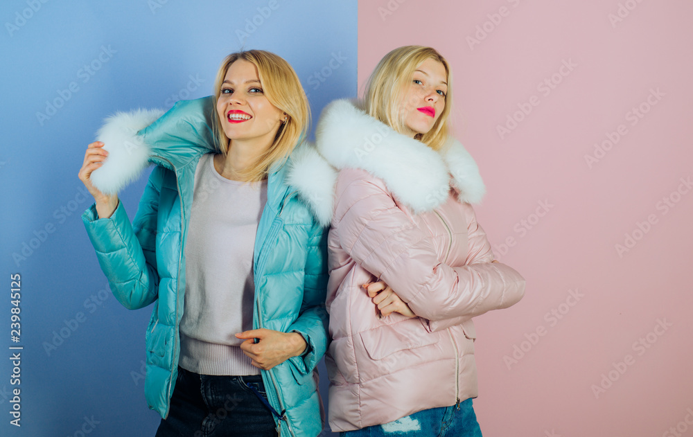Obraz premium Mixing comfort with elegance. Sexy women wear warm winter coats. Pretty women in fashionable puffers. Fashion models in hoods with fur. Winter fashion trends. Keeps warm and looks good