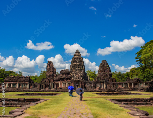 NAKHON RATCHASIMA, THAILAND - OCTOBER 14, 2018 : The tourist walking in Khmer historic site with blue sky and white cloud background on October 14, 2018 in Nakhon Ratchasima, Thailand. © aaor_2550