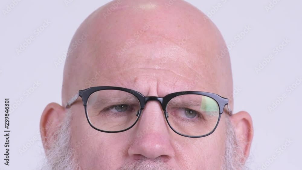 Eyes of mature bald bearded man with eyeglasses thinking Eyes of mature bald bearded man with eyeglasses thinking