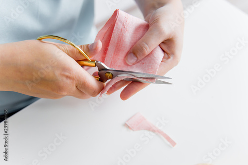 female hands are using a sewing machine