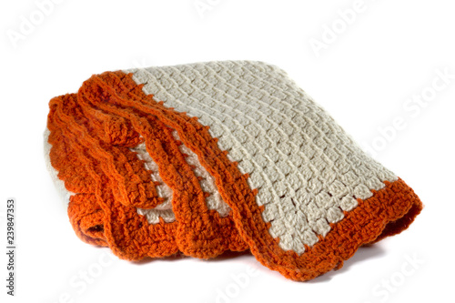 Handcrafted Orange and cream crochet afghan throw blanket isolated on a white background